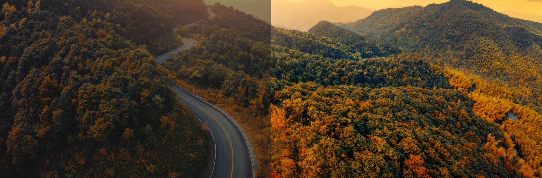 A scenic road winds through the Colorado mountains, surrounded by vibrant fall foliage in shades of red, orange, and gold, with rugged peaks rising in the background under a clear sky